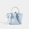 Light blue quilted bucket handbag for women with elegant ribbon and adjustable crossbody strap. - Light Blue