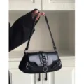 Dettaglio borsa a spalla nera stile moto in pelle con fibbie in metallo argentato. - Nero
