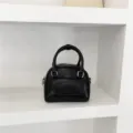 Minimalist black mini shoulder bag with top handle and front flap pocket for women style. - Standard / Black