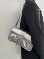 Metallic silver motorcycle shoulder bag detail shot, featuring multiple pockets and metal hardware. - Silver