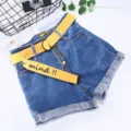 Women denim shorts with yellow canvas belt, high waist and rolled cuff design for casual summer. - Yellow