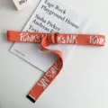 Orange canvas belt with metal D-ring buckle and white letter print for casual wear. - Orange