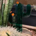Close-up of green acrylic cactus decor with orange flower accents for cute desk display. - Waving Cactus Pillar / 15.5x19cm
