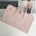 Detailed close-up of pink PU leather laptop sleeve featuring chic metal lock and sturdy handle. - Medium (14-15 Inch) / Sakura Pink