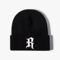 Black knit beanie with white gothic letter embroidery, stylish streetwear for outdoor wear. - Adjustable / Black