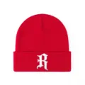 Close-up red knit beanie hat featuring detailed white gothic letter R embroidery design. - Adjustable / Red