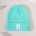 Mint green knit beanie detail shot, featuring white Gothic letter R embroidery on the front cuff. - Adjustable / Lake Blue