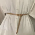 Slim leather belt for women, minimalist waist accessory with oval metal buckle in khaki. - Khaki