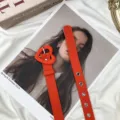 Cintura in tessuto arancione da donna con fibbia a forma di cuore e occhielli metallici. - Arancione