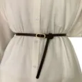 Minimalist women's thin brown leather belt with gold-toned oval buckle for dresses and shirts. - Coffee
