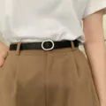 Minimalist women thin black leather belt with chic metal oval buckle for dress styling. - Black