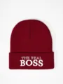 Burgundy knit beanie detail showcasing white embroidered lettering on the folded cuff. - One Size / Burgundy