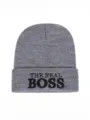 Close up of grey knitted beanie hat with black embroidery detail, comfortable winter wear. - One Size / Medium Heather Grey