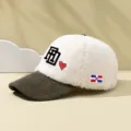 Close-up detail of cozy faux shearling and corduroy colorblock baseball cap with embroidery. - Adjustable / White