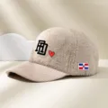 Detailed view of the fuzzy lamb wool baseball cap featuring stylish embroidery and corduroy brim. - Adjustable / Beige