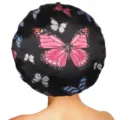 Close-up detail of the black satin sleep bonnet featuring colorful butterfly prints, soft and smooth. - One Size / Black