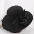 Detailed view of black wool felt Hepburn hat, featuring elegant mesh veil, feathers and floral decor. - M (56-58cm) / Mesh Floral Black
