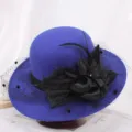 Detailed shot of elegant blue wool bucket hat with black mesh fabric flower and feather decor. - M (56-58cm) / Mesh Floral Royal Blue