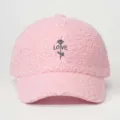 Close-up of pink faux shearling baseball cap detail, featuring delicate rose and love embroidery. - Adjustable / Pink