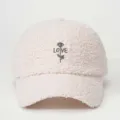 Close-up detail of cozy faux shearling baseball cap featuring embroidered rose and love text. - Adjustable / Beige