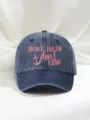 Detailed view of the washed blue denim baseball cap featuring pink anchor embroidery. - Adjustable / Navy Blue