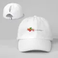 Detail view of white ponytail baseball cap with cute strawberry print and adjustable strap. - Adjustable / White