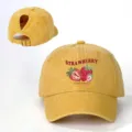 Detailed view of the yellow washed denim baseball cap with ponytail hole and strawberry print. - Adjustable / Yellow