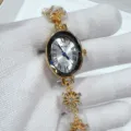 Gold oval quartz watch detail, delicate snowflake bracelet design, elegant women jewelry watch. - Gold White Face