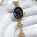 Elegant women's oval quartz watch with black Roman dial and gold snowflake chain strap detail. - Gold Black Face