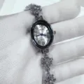 Detailed view of women's elegant oval quartz watch with crystal snowflake bracelet. - Silver Case White Dial