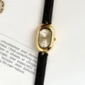 Montre bracelet pour femme au design vintage, boîtier ovale et bracelet en cuir noir. - Boîtier Doré Cadran Blanc Bracelet Noir
