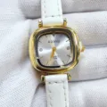 Close-up detail of the elegant vintage square dial quartz watch with a white leather strap. - Gold Case White Dial White Strap