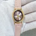 Kloris women's quartz watch detail featuring an elegant oval rhinestone bezel and pink leather strap. - Gold Case Pink Dial Pink Strap