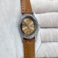 Detail view of elegant oval rhinestone quartz watch with brown leather strap and Roman numerals. - Silver Case Brown Dial Brown Strap