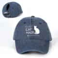 Detailed view of the washed denim ponytail baseball hat with cat quote print and metal buckle. - Adjustable / Navy Blue