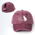 Close-up details of washed burgundy ponytail baseball cap with cute cat print and strap. - Adjustable / Burgundy