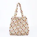 Detail view of the bohemian woven mesh tote bag with colorful beaded design for women vacation. - Off-White Single-Sided