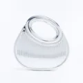 Silver metallic rigid evening bag detail, showing vertical striped texture and smooth ring handle. - Silver
