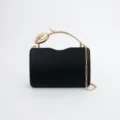 Black evening clutch bag with gold tulip metal handle and chain strap for women detail view. - Black
