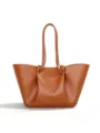 Brown leather slouchy tote bag detail showing knotted handles and metal ring accents. - Brown
