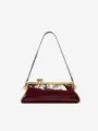 Detailed view of luxury burgundy alligator embossed shoulder bag with gold hardware and clasp. - Burgundy