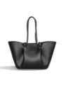 Black leather tote bag detail showcasing pleated cloud design and elegant handle craftsmanship. - Black