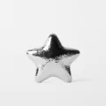 Silver metallic star clutch detail shot, unique designer evening bag surface texture and shine. - Silver