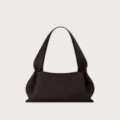 Dark brown leather shoulder bag detail, slouchy minimalist design, premium texture. - Coffee