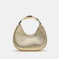 Gold metallic woven handbag detail, featuring unique crescent shape and curved metal handle. - Gold
