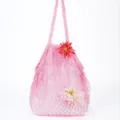 Detailed close-up view of the pink knit mesh beach tote bag with cute flower decor. - Pink