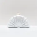 Detail view of white acrylic shell clutch with dual pearl clasp for women evening party. - White