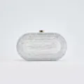 Detailed view of the elegant marble pattern acrylic evening clutch bag with gold tone clasp. - White