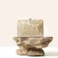 Detailed shot of elegant acrylic box clutch with layered geometric texture and metal clasp. - Champagne