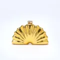 Golden shell shaped evening clutch bag detail view showcasing smooth glossy metallic finish. - Gold